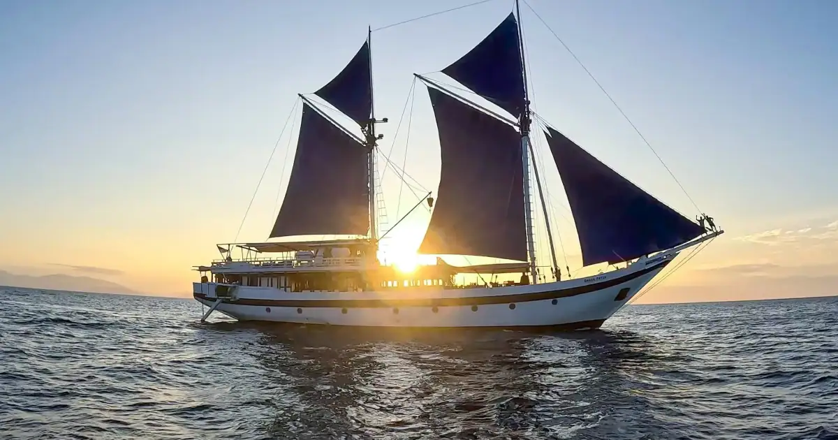 Ombak Putih pinisi ship with sunset background