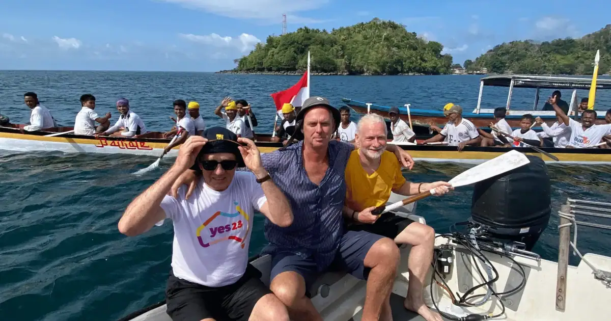 Barry Clarke and fellow SeaTrek guest taking photo with Kora-Kora from the tender