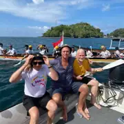 Barry Clarke and fellow SeaTrek guest taking photo with Kora-Kora from the tender