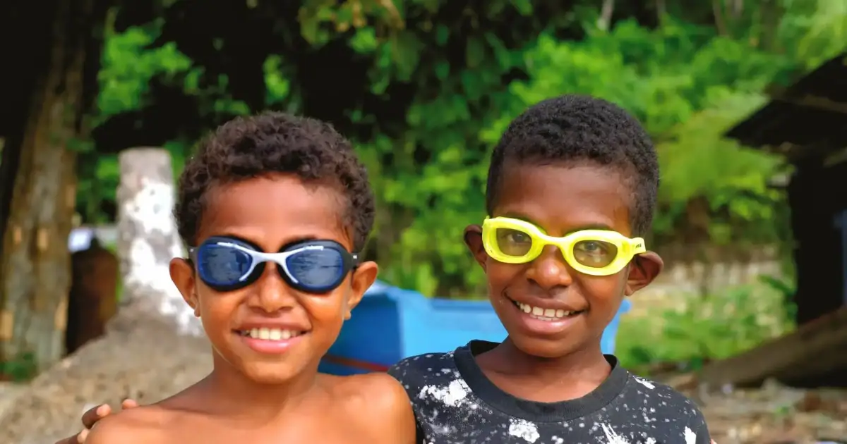 Happy kids pose using their goggles from SeaTrek