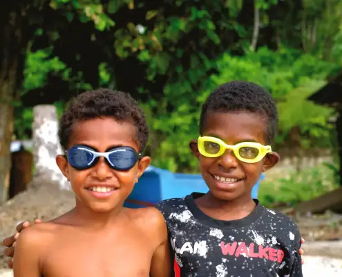 Happy kids pose using their goggles from SeaTrek