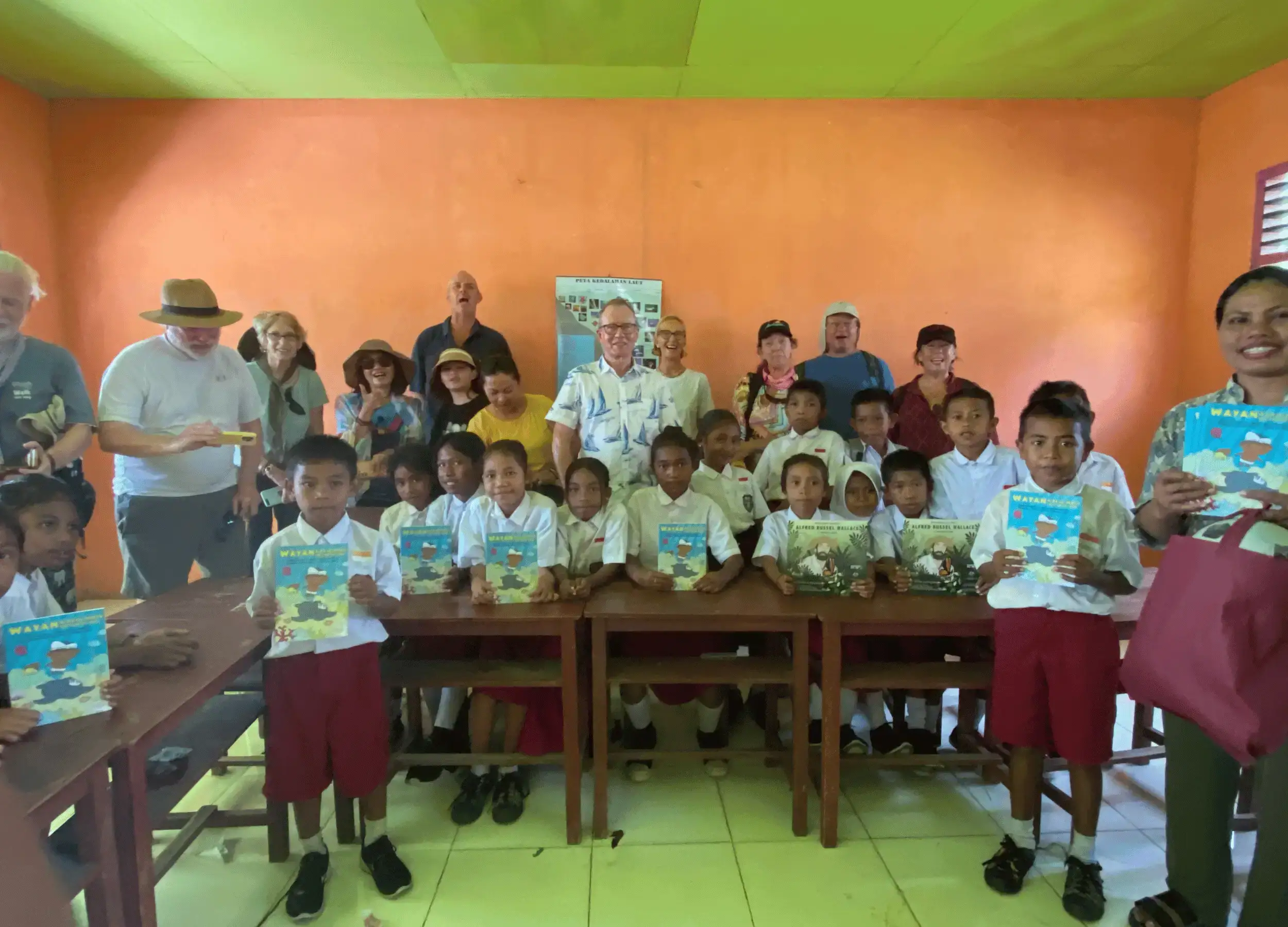 SeaTrek distributing the Wayan and the Turtle King book to kids in the school.