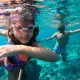 a dad and daughter enjoy family snorkeling trip