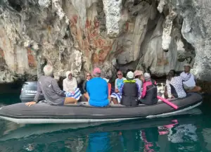SeaTrek's guests visiting the Prehistoric cave painting in Raja Ampat using tender