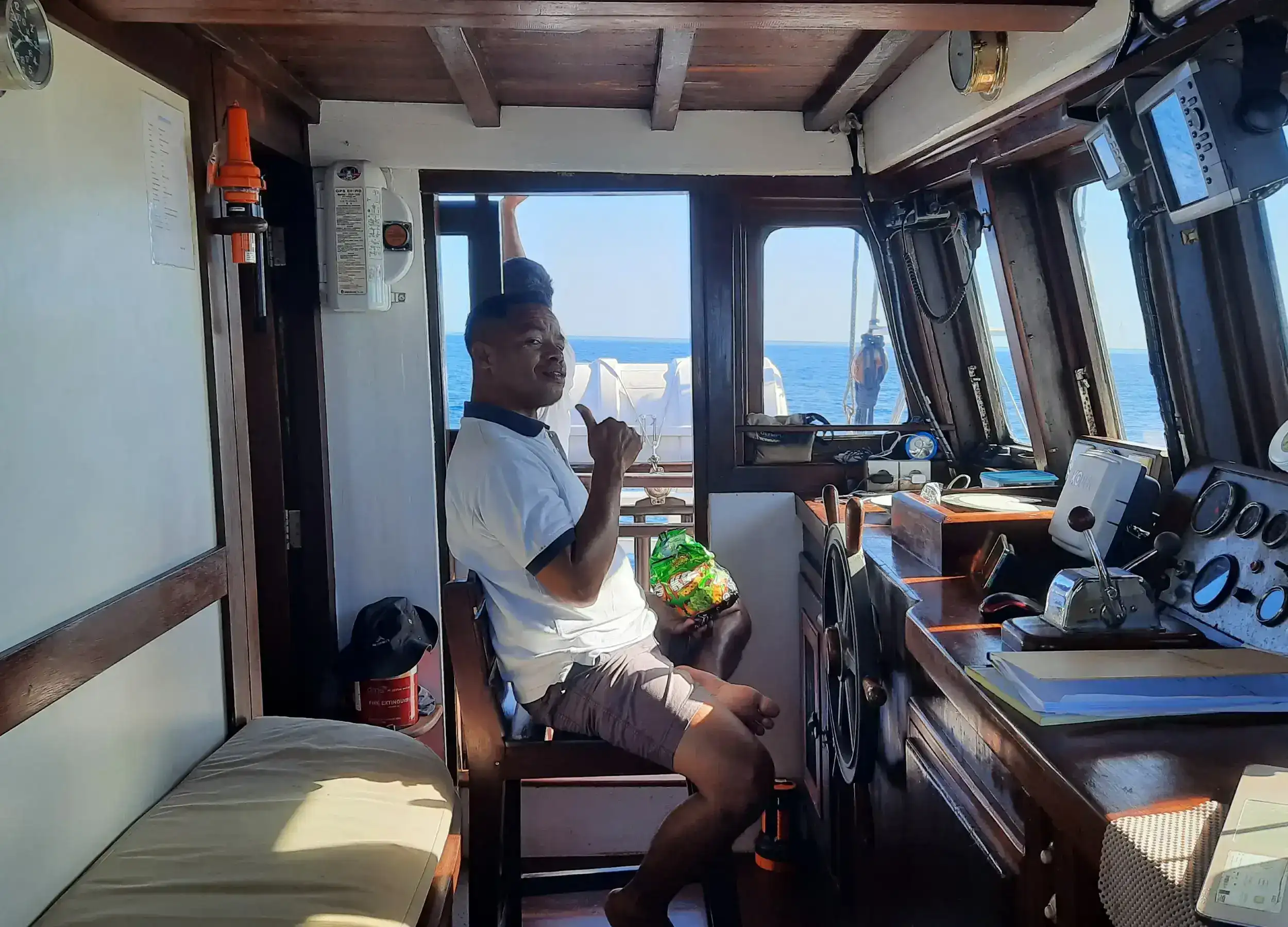 Toni steering the Ombak Putih.
