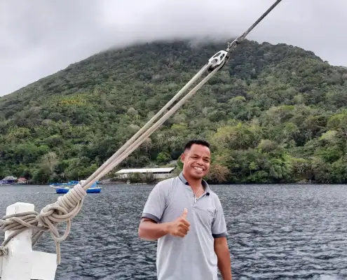 Toni with the Gunung Api background in Banda. (Abd. Wahab/SeaTrek Sailing Adventures)