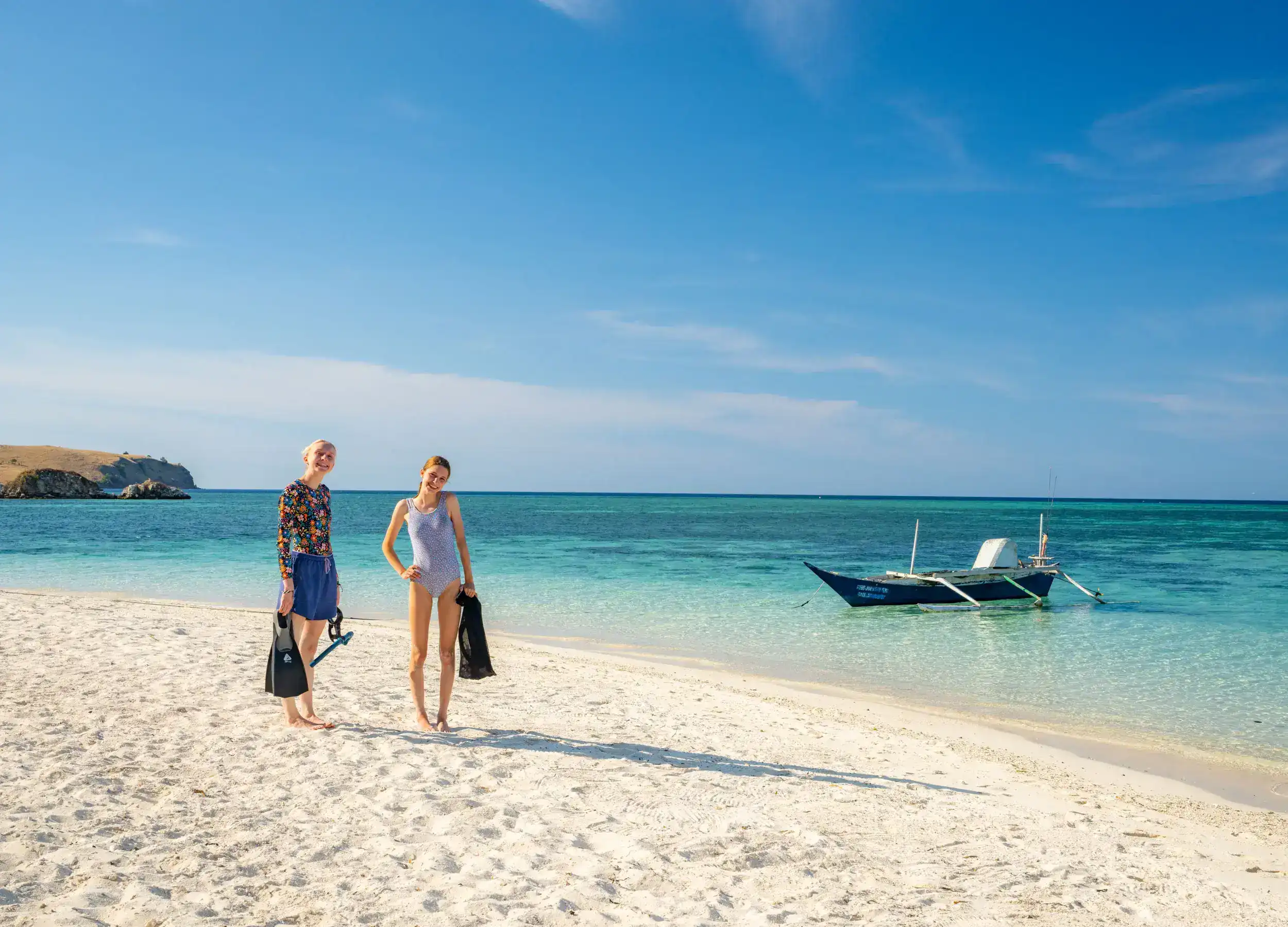 Happy guest at the white sandy beach before snorkeling