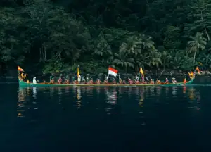 A group of men paddling the Kora-Kora boat in Banda