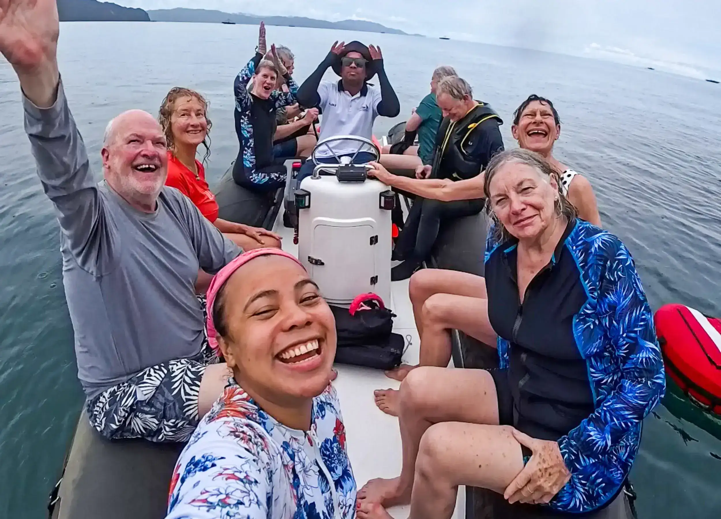 group photo on the dinghy with happy face after swim with whale sharks