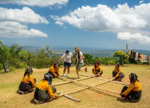 A guest joins the bamboo dance performance at the Melo Village.