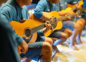 Crew playing band at the BBQ beach