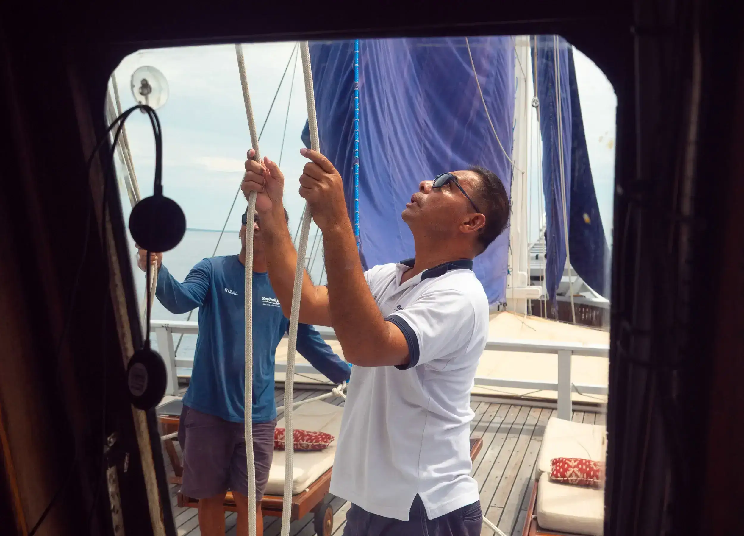 Captain Jufri and crew preparing the sails